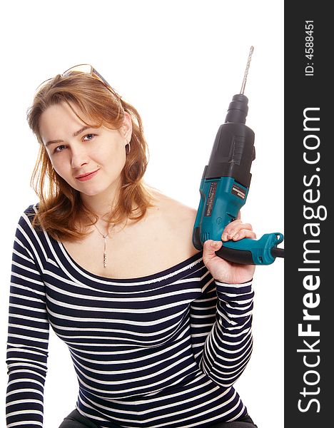 The beautiful girl holds a drill. The beautiful girl holds a drill