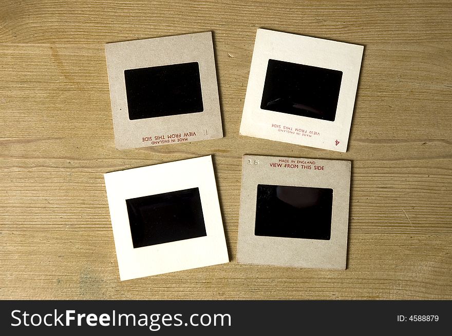 Four old Slides on a wood background