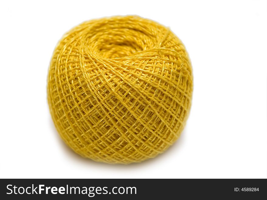 Yellow sewing clew on the white isolated background