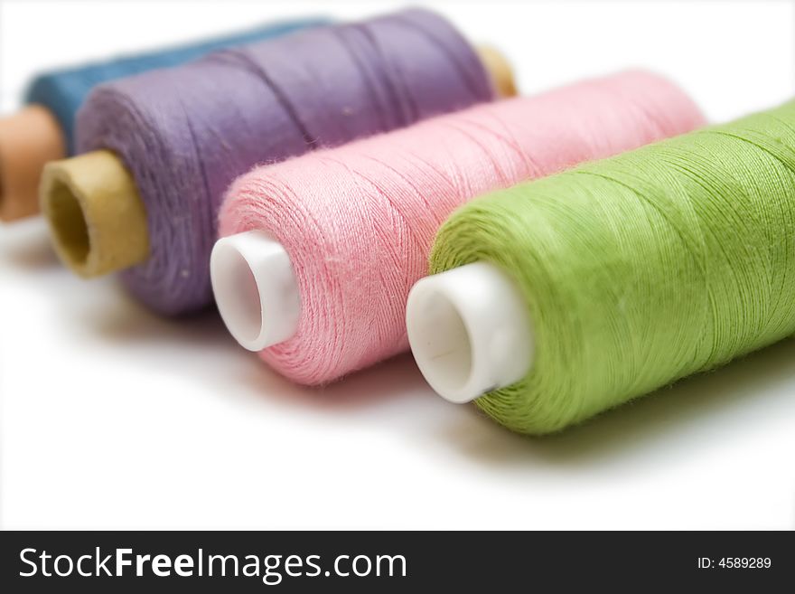 Multi-colored sewing on the white isolated background