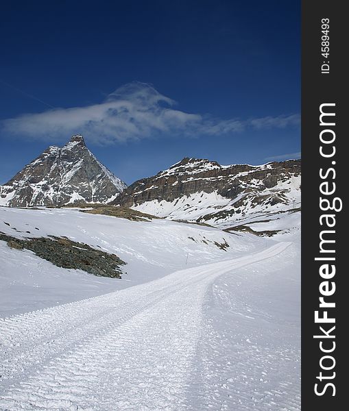 Mountain peak Matterhorn, road heading there, sight from Italy