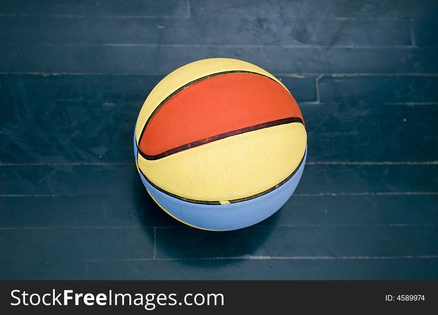 Very colorful basketball ball on wood floor