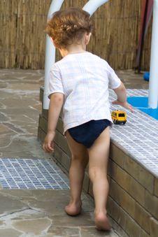 Curly Boy At A Pool (07) Royalty Free Stock Photo
