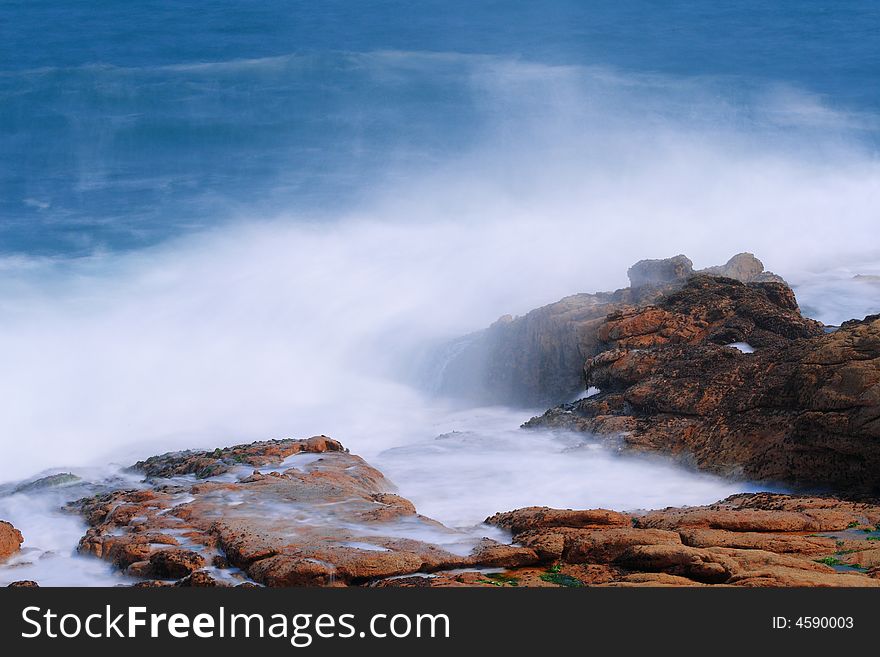 A cloudy wave is along the coast.