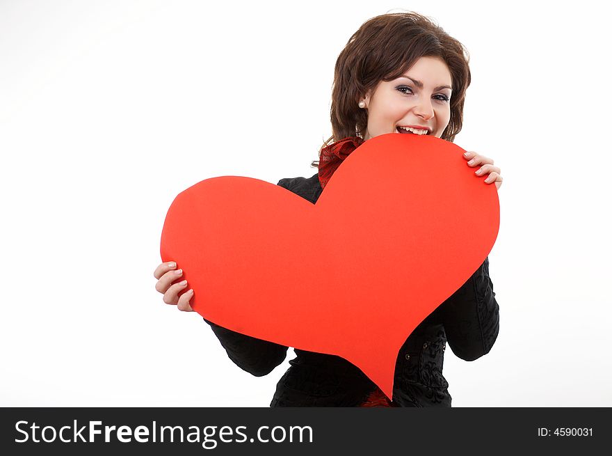 A woman biting a big red paper heart. A woman biting a big red paper heart