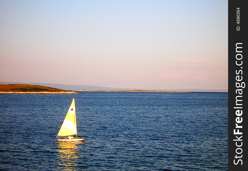 Rowing sailing boat in Croatia sea - in the evening light. Rowing sailing boat in Croatia sea - in the evening light