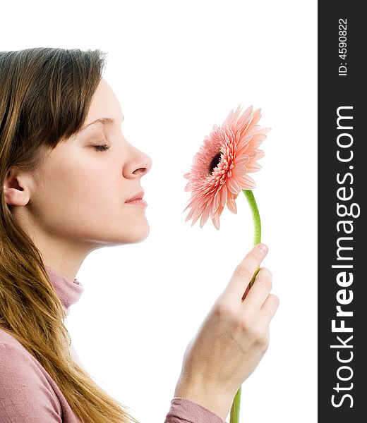 Girl on white background smelling pink flower. Girl on white background smelling pink flower