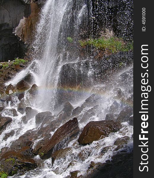 Waterfall with rainbow in mountains