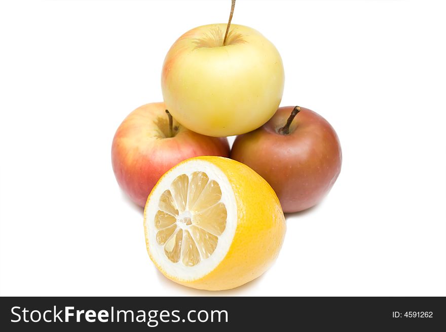 Three apples and lemon on the whie isolated background