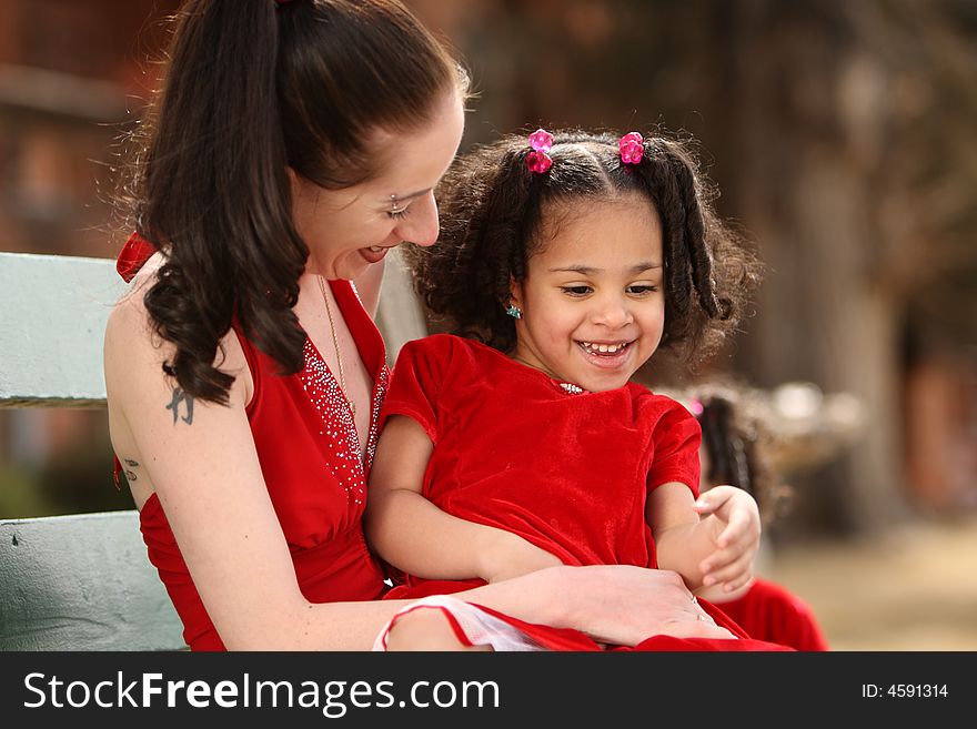 Beautiful multiracial childwith afro hairstyle playing with mother. Beautiful multiracial childwith afro hairstyle playing with mother