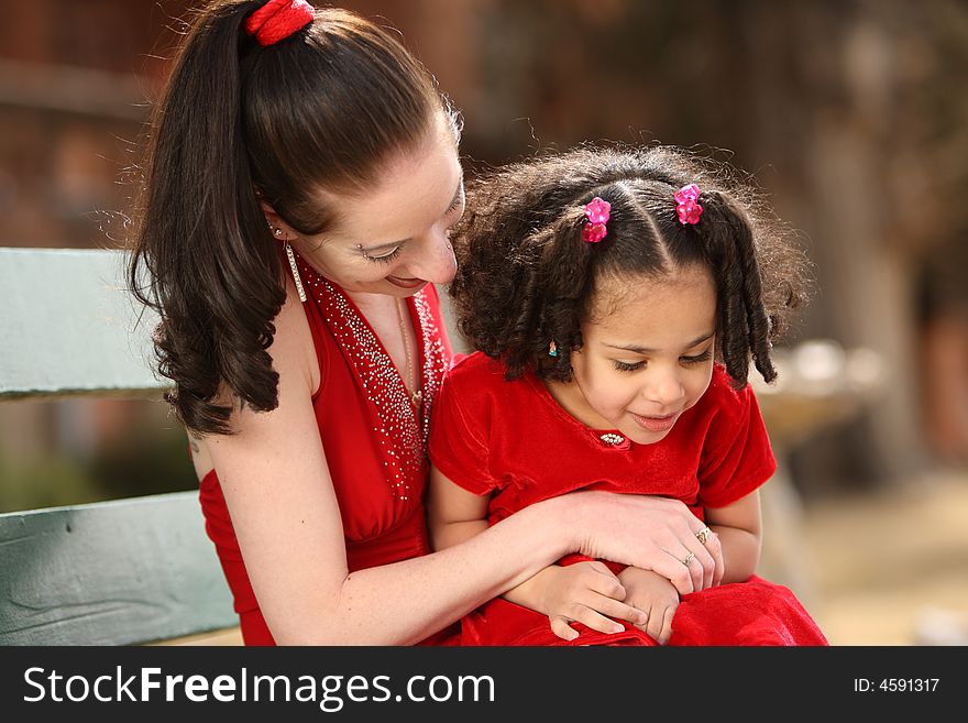 Beautiful multiracial child with afro hairstyle playing with her mother. Beautiful multiracial child with afro hairstyle playing with her mother