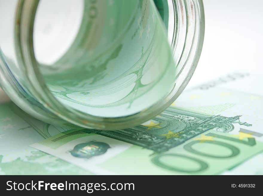 Some 100 euros banknotes in jar over white isolated background