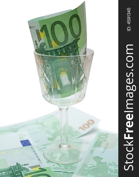 One 100 euro banknote in wineglass over white isolated background