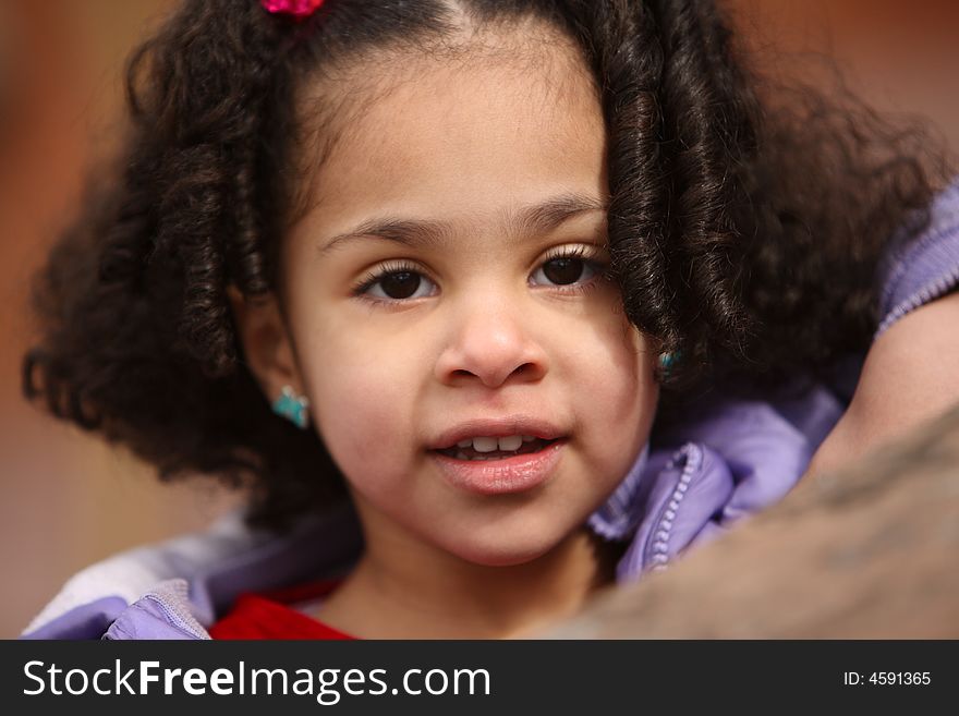 Beautiful multiracial child with afro hairstyle playing playing