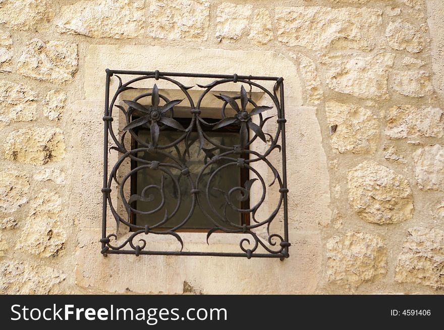 A fancy framed window in the street wall. A fancy framed window in the street wall