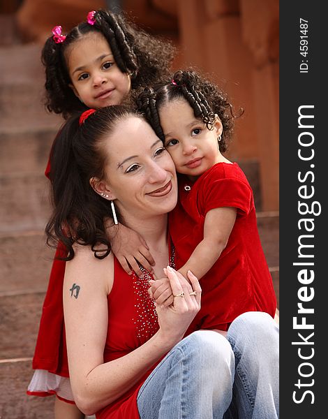 Beautiful multiracial children with afro hairstyle playing with mother. Beautiful multiracial children with afro hairstyle playing with mother