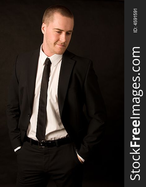 Portrait of a young businessman on dark background