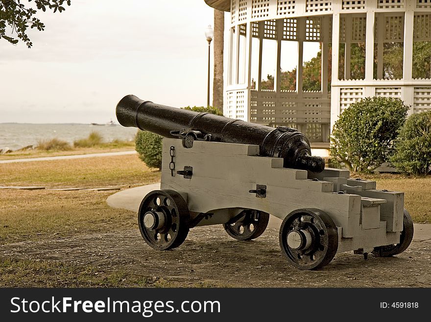 A cannon pointing out to sea at a beach side park. A cannon pointing out to sea at a beach side park
