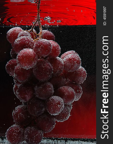 Red Grapes In Water on black with red background