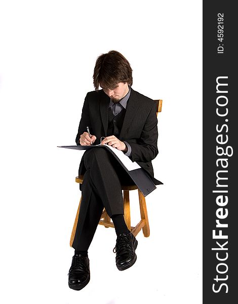 A young and pretty businessman sitting and working. A young and pretty businessman sitting and working