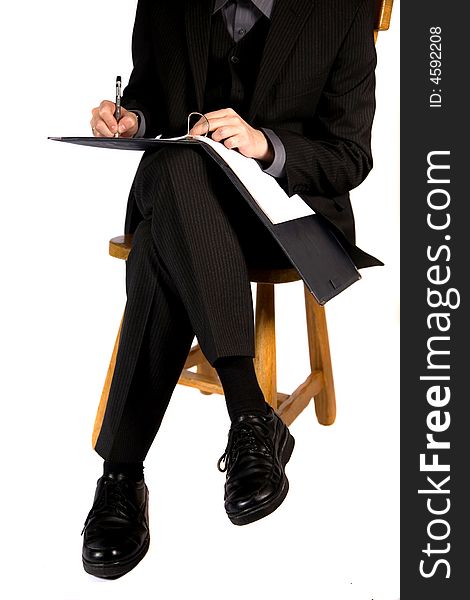 A young businessman sitting and working. A young businessman sitting and working