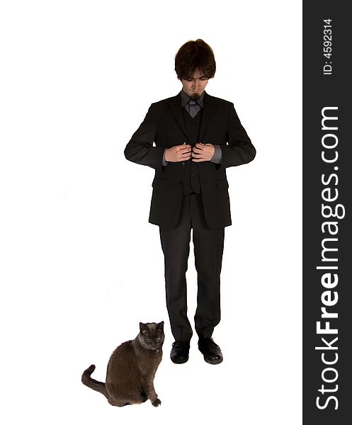 A young and pretty businessman standing next to a cute black cat. A young and pretty businessman standing next to a cute black cat