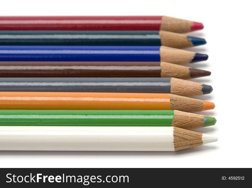 A row of colored pencils shot against a white background.