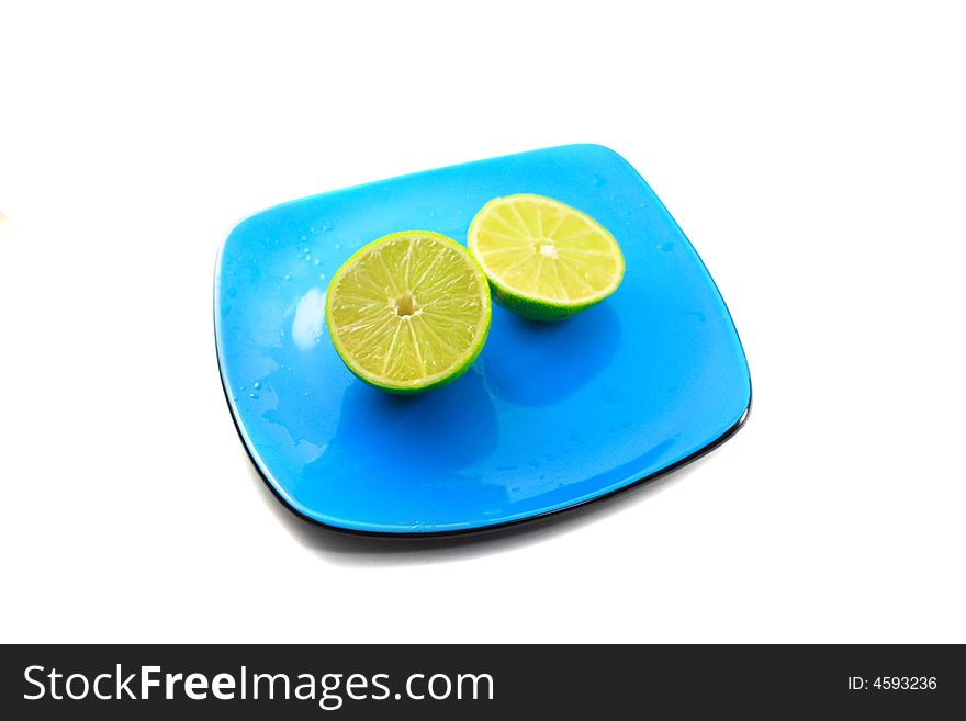 Shot of limes on blue plate with isolated white background.