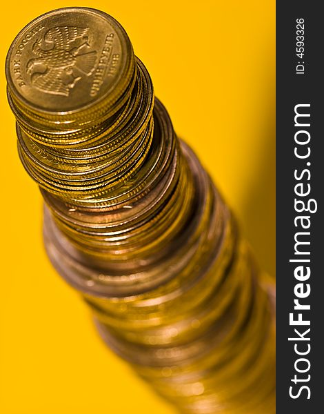 Money series: coins on the yellow background. Money series: coins on the yellow background