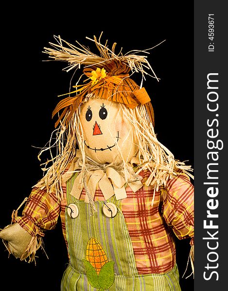 Autumn decoration, scarecrow on a black background with copy space. Autumn decoration, scarecrow on a black background with copy space