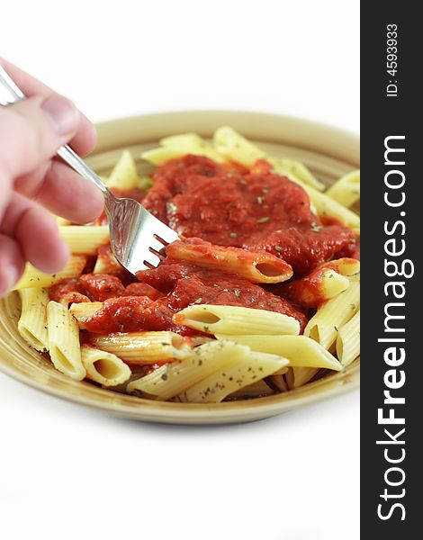 Hand holding fork to eat pasta with. Hand holding fork to eat pasta with.