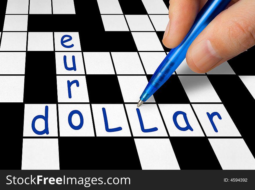 Hand filling in crossword - euro and dollar, business concept