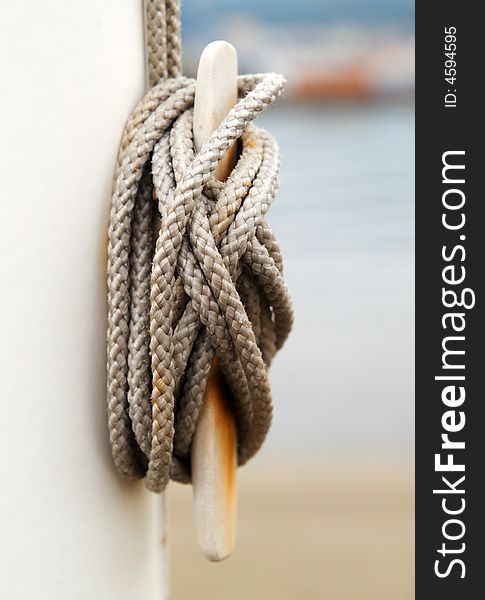A rolled up rope with a blurred beach in the background