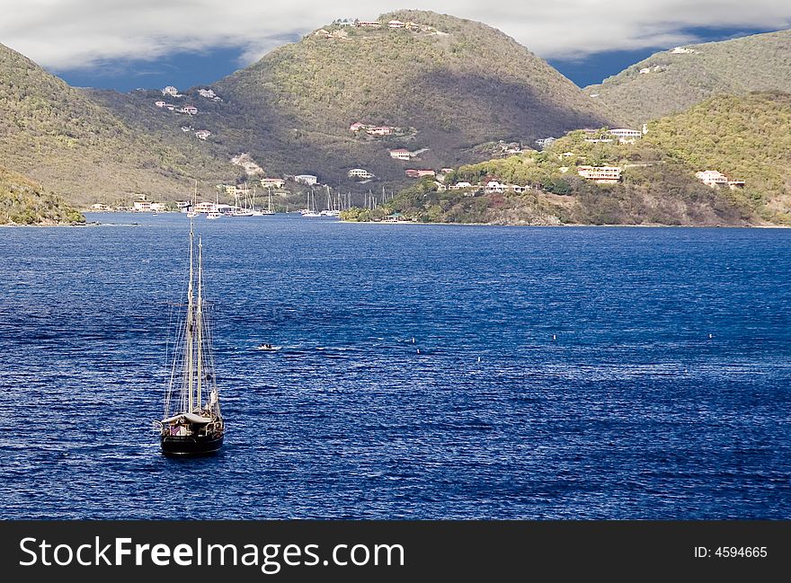 Lone sailboat with British Virgin Islands in background. Lone sailboat with British Virgin Islands in background.