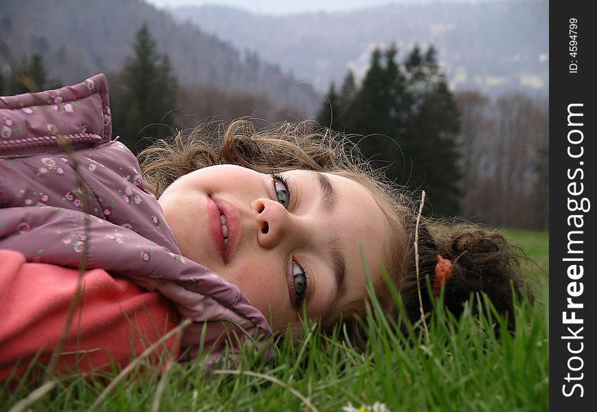 Little girl laying on the green grass. Little girl laying on the green grass