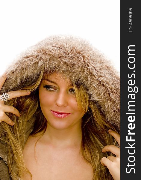 Fashion portrait of a young woman in a hooded fur jacket. Fashion portrait of a young woman in a hooded fur jacket