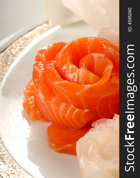 Delicious raw salmon sashimi in a flower shape. Delicious raw salmon sashimi in a flower shape