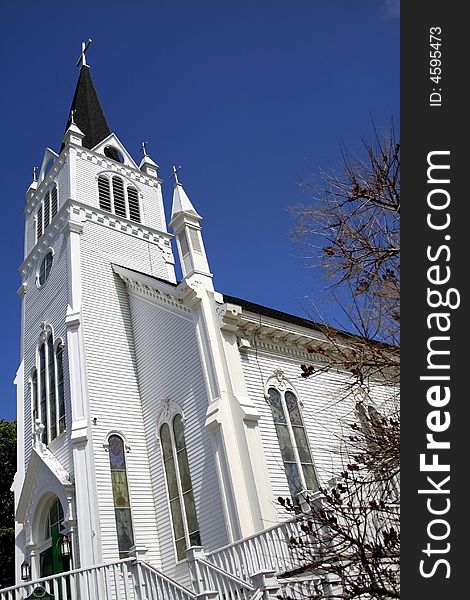 Wide angle shot of white church with blue sky background. Wide angle shot of white church with blue sky background
