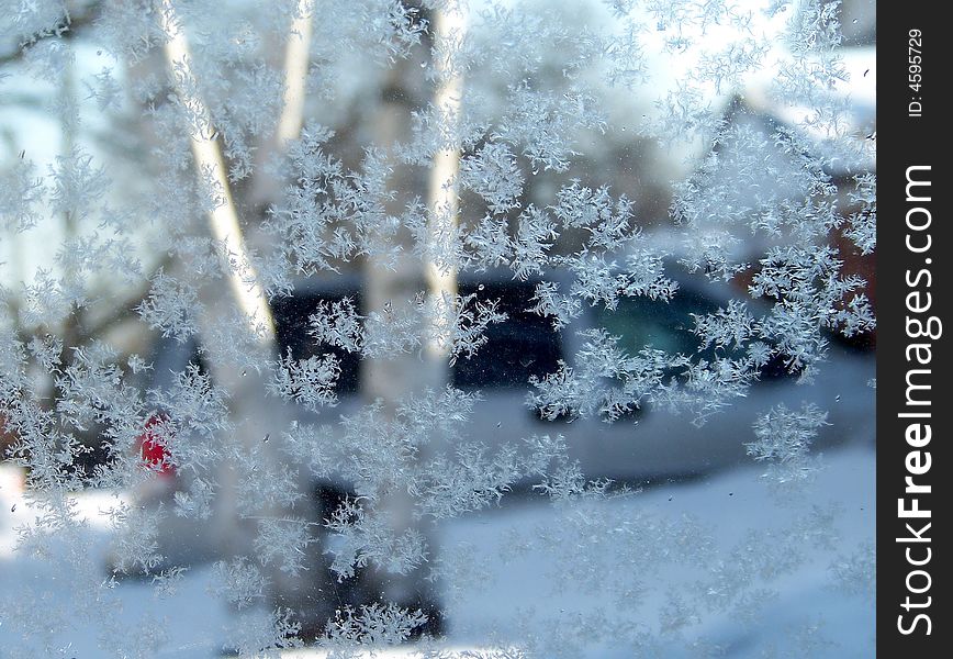 View through the window with snowflakes as a background. View through the window with snowflakes as a background
