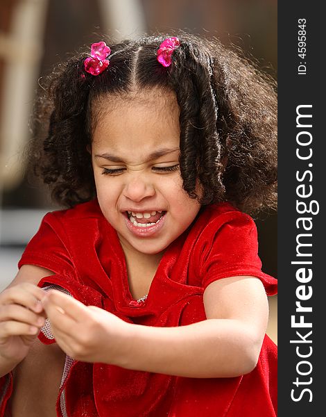 Beautiful multiracial child with afro hairstyle playing playing