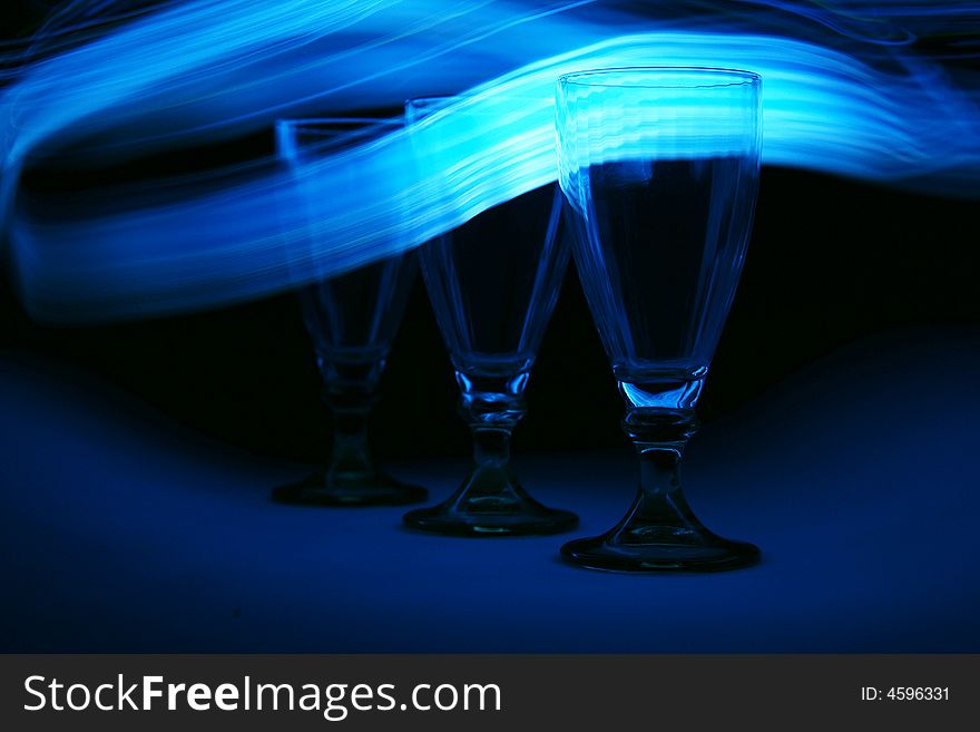 Three wine glasses in blue light. Three wine glasses in blue light