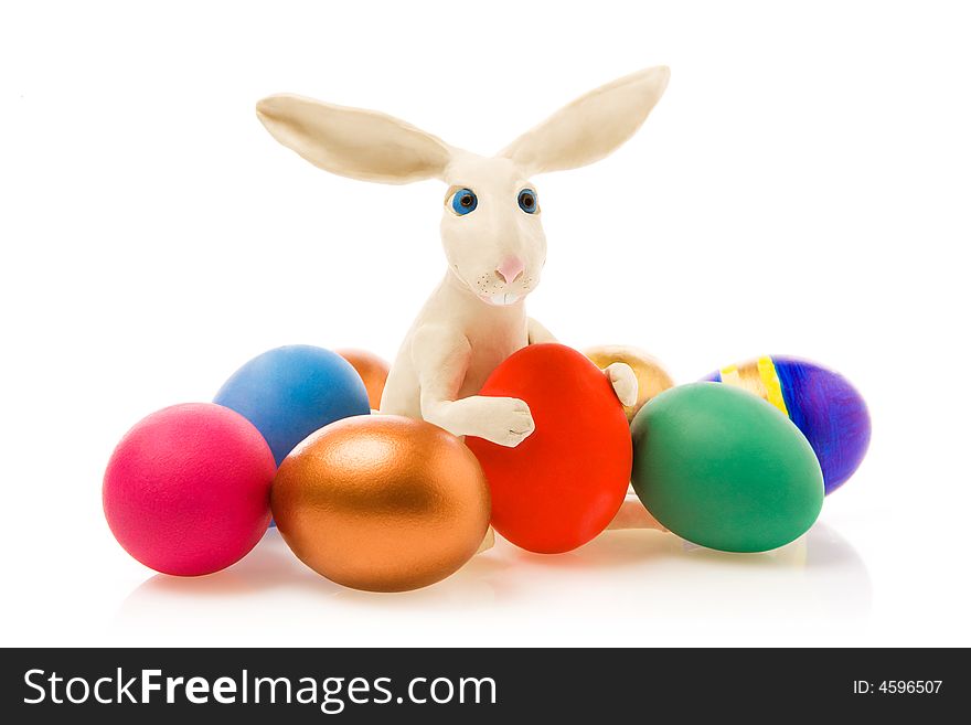 Rabbit sits near to  Easter eggs.The image contains a path. Rabbit sits near to  Easter eggs.The image contains a path.