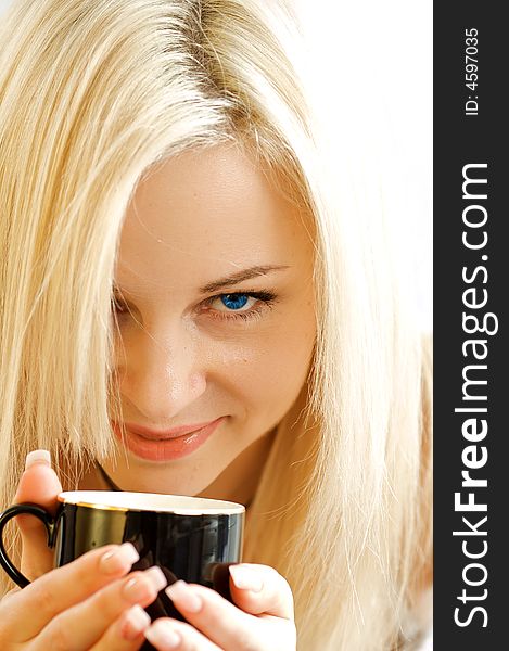 Portrait of the girl with an expressive sight and a mug of coffee. The isolated photo in studio on a white background. Portrait of the girl with an expressive sight and a mug of coffee. The isolated photo in studio on a white background.