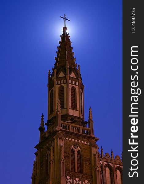 The Church in the night. The full moon are shading behind the church's Latin corss. The Church in the night. The full moon are shading behind the church's Latin corss.