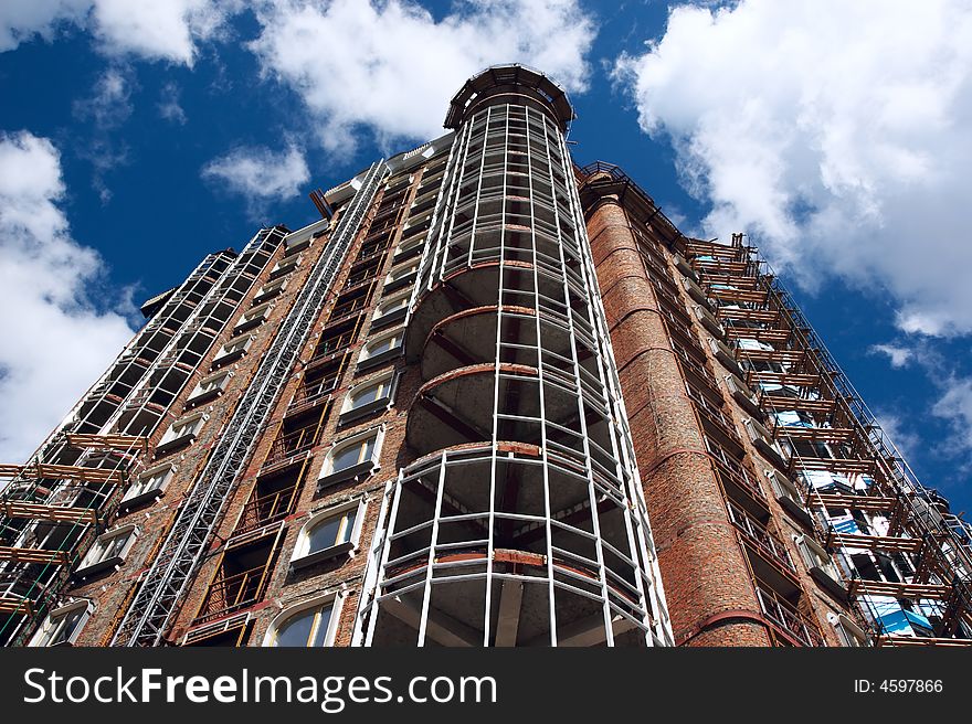 Beautiful apartment house under construction on sky background. Beautiful apartment house under construction on sky background