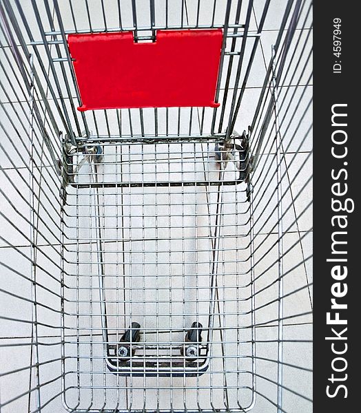 The empty shopping trolley cart. The empty shopping trolley cart