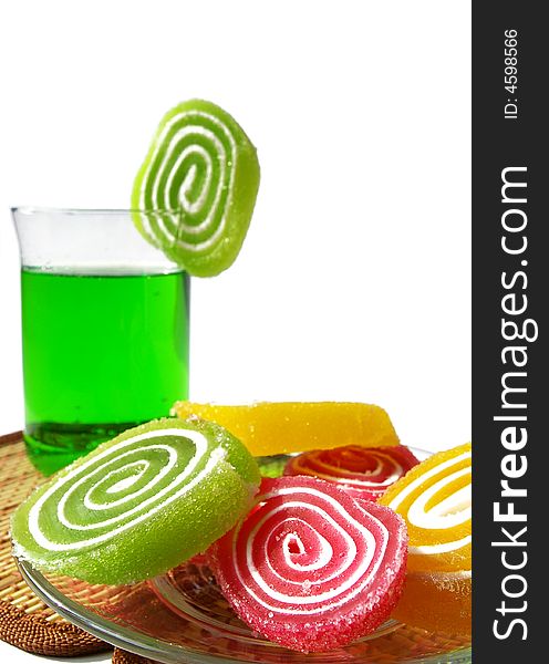 Multi-coloured  fruit candy and cold green drink