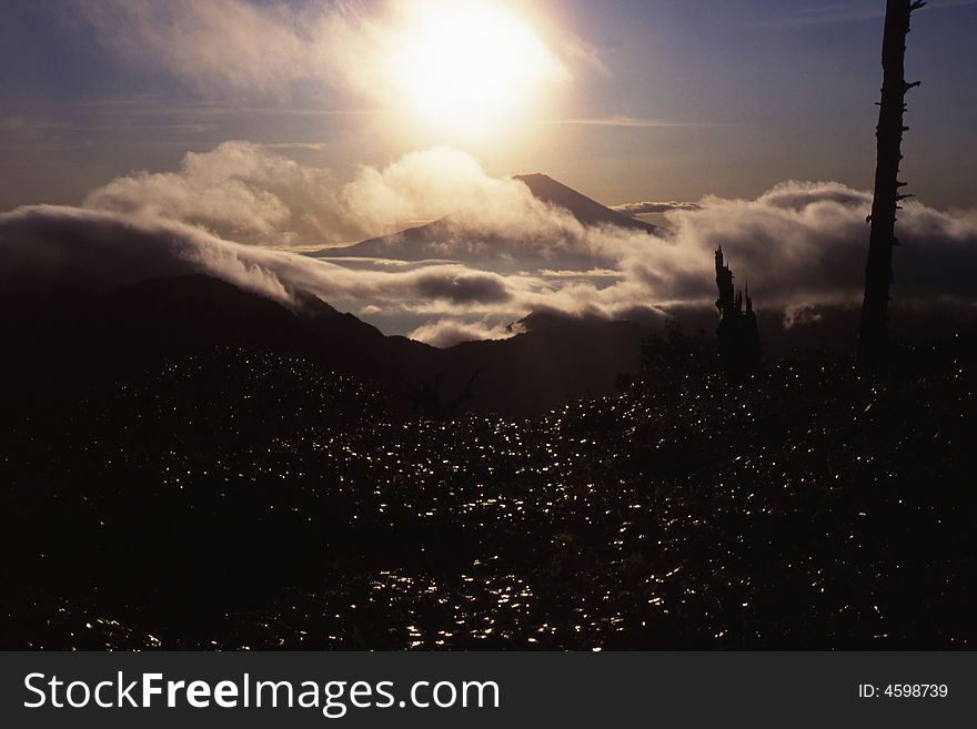 Sunrise over Mt. Fuji as viewed from an adjacent peak. Sunrise over Mt. Fuji as viewed from an adjacent peak