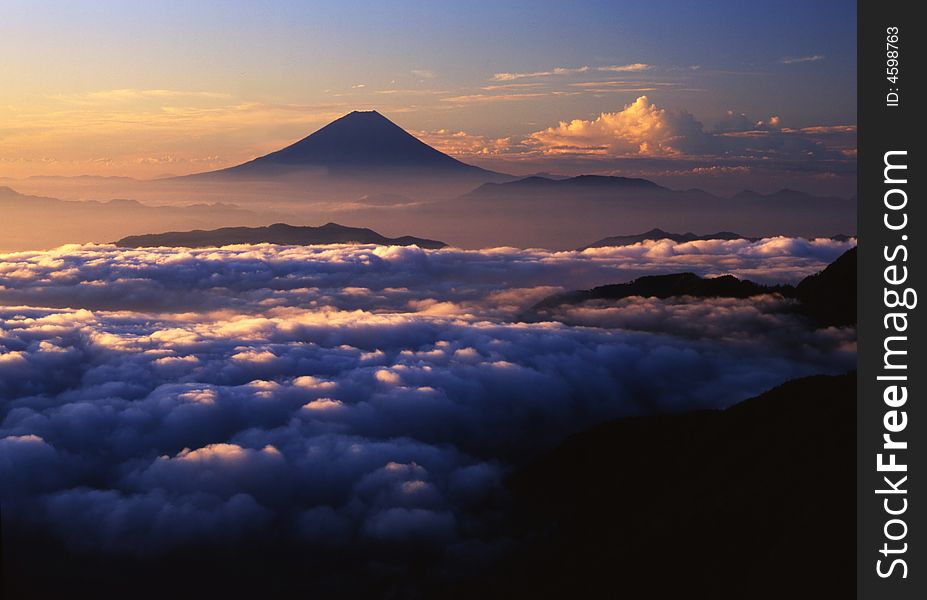 Majestic Mount Fuji rising up through a sea of clouds. Majestic Mount Fuji rising up through a sea of clouds