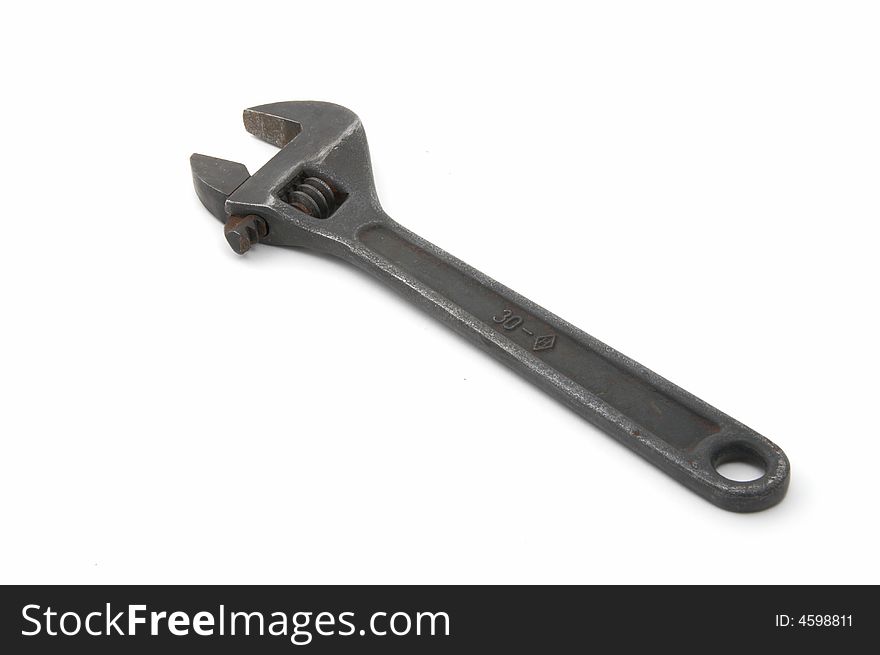Iron adjustable spanner on a white background